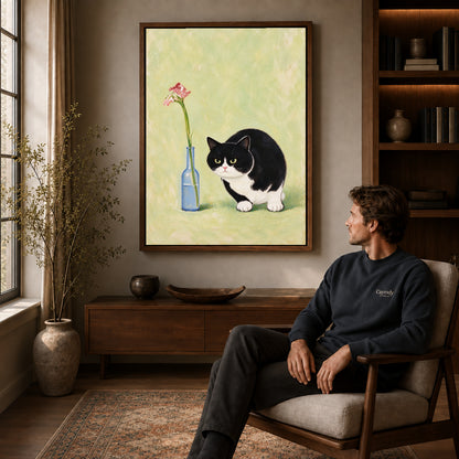 cat flower companion canvas art in a walnut frame above a console beside a seated man.