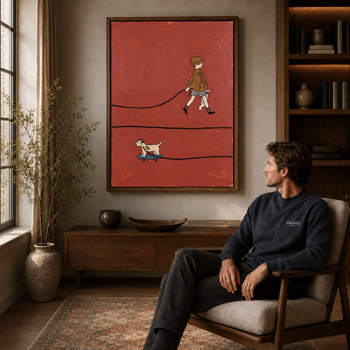 skateboard dog walk canvas art in a walnut frame above a console beside a seated man.