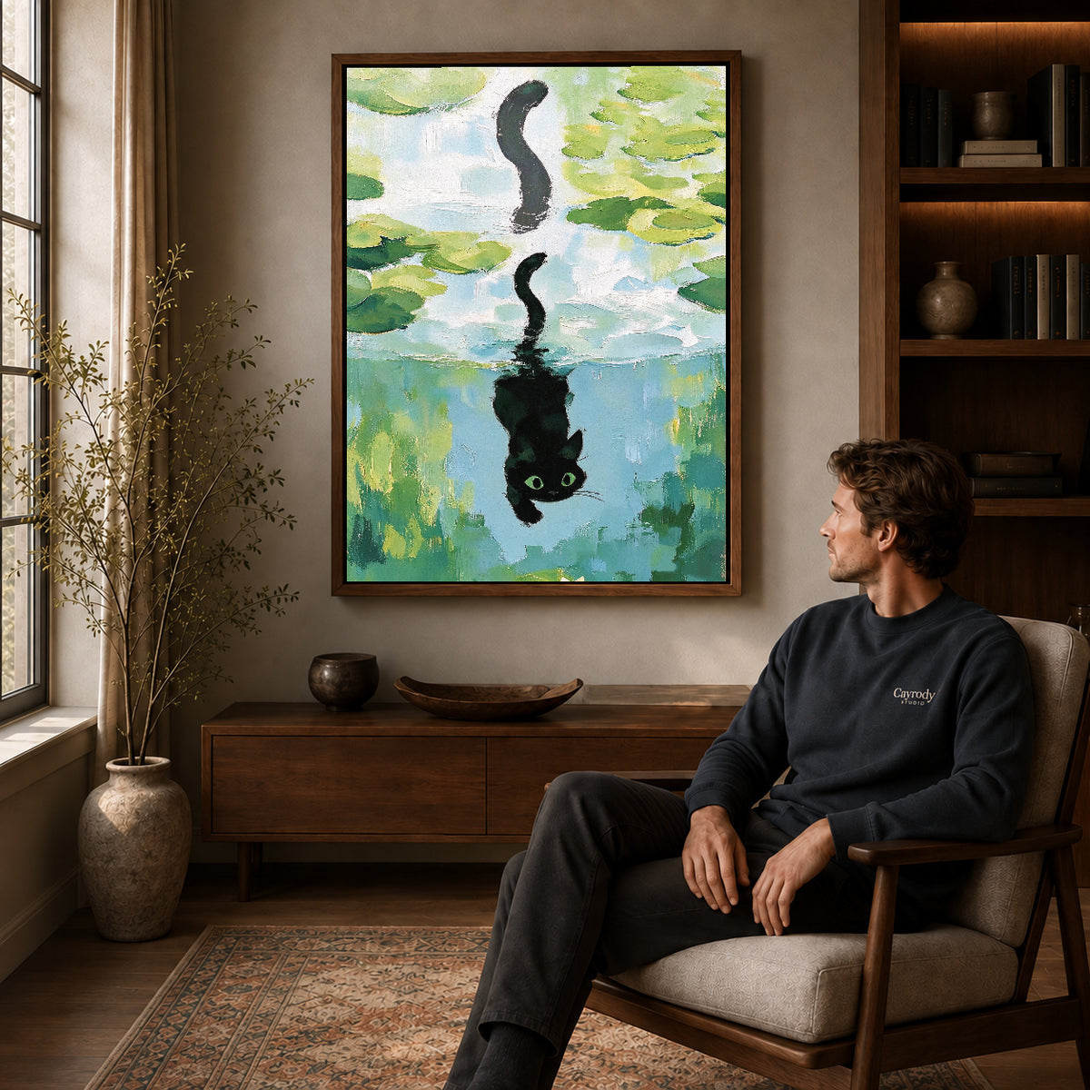 lily pond reflection canvas art in a walnut frame above a console beside a seated man.