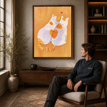 two tender cats canvas art in a walnut frame above a console beside a seated man.