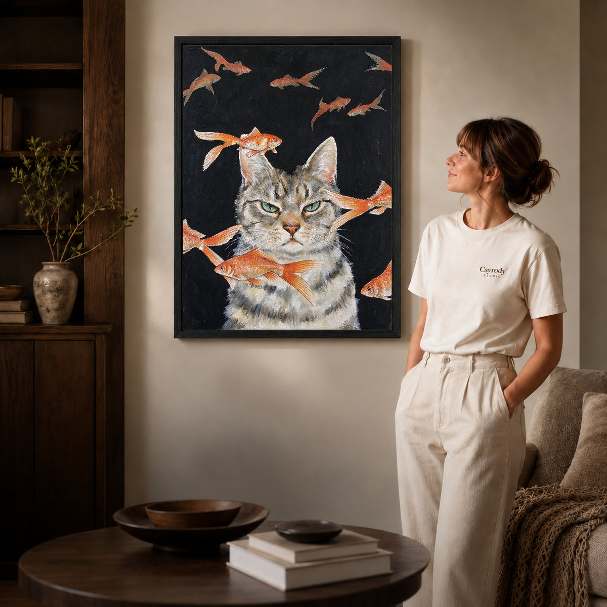 goldfish dreaming cat canvas art shown in the black frame option against a softly lit wall.