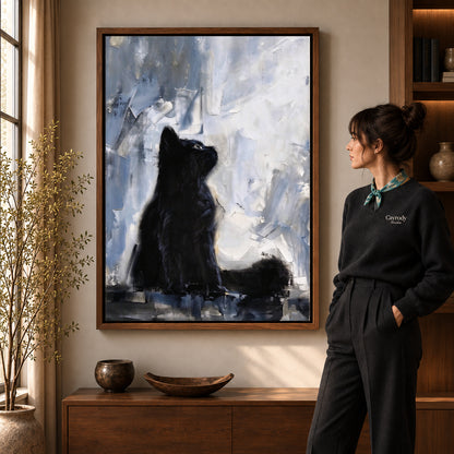 quiet black kitten canvas art in a walnut frame beside a standing woman and wooden console.