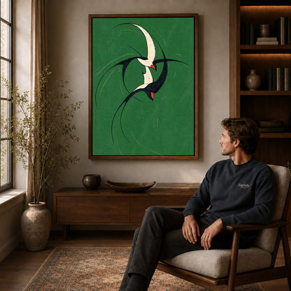 graceful swallow pair canvas art in a walnut frame above a console beside a seated man.