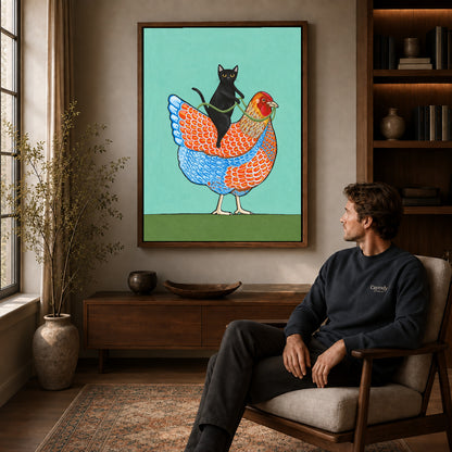 cat riding hen canvas art in a walnut frame above a console beside a seated man.