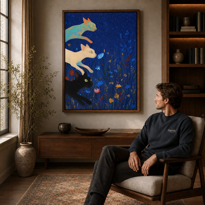 starry meadow cats canvas art in a walnut frame above a console beside a seated man.
