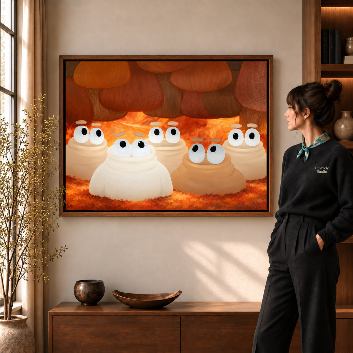 curious woodland friends canvas art in a walnut frame beside a standing woman and wooden console.