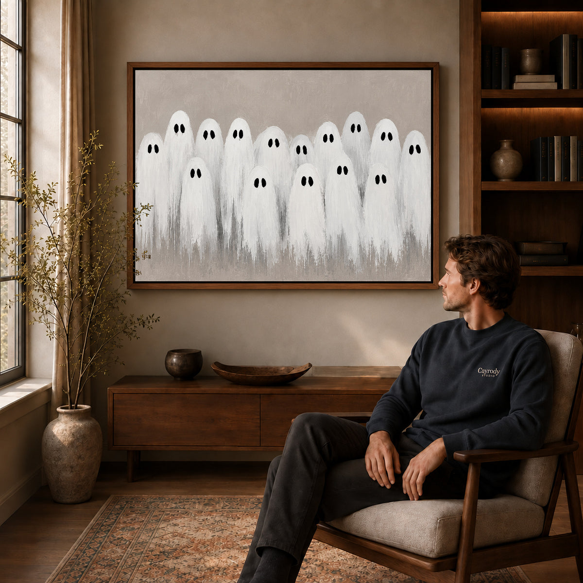 friendly ghost gathering canvas art in a walnut frame above a console beside a seated man.