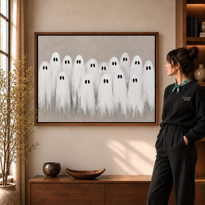 friendly ghost gathering canvas art shown in the walnut frame option within a warm living room.