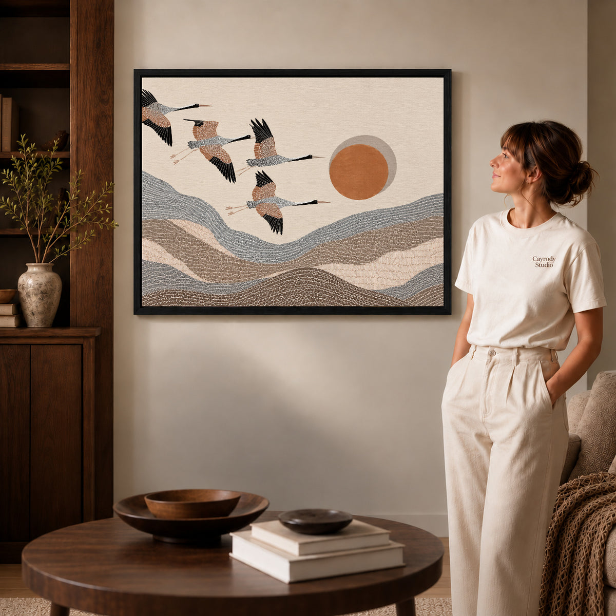 cranes mountain flight canvas art shown in the black frame option against a softly lit wall.