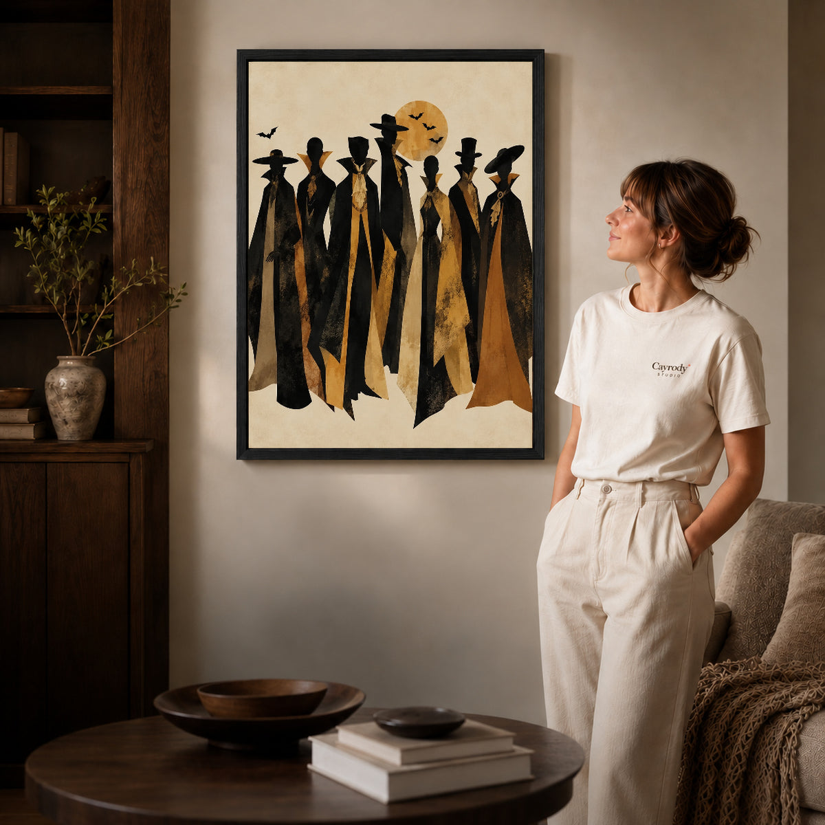 autumn cloaked gathering canvas art shown in the black frame option against a softly lit wall.