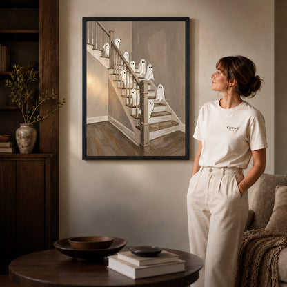 staircase ghost gathering canvas art shown in the black frame option against a softly lit wall.