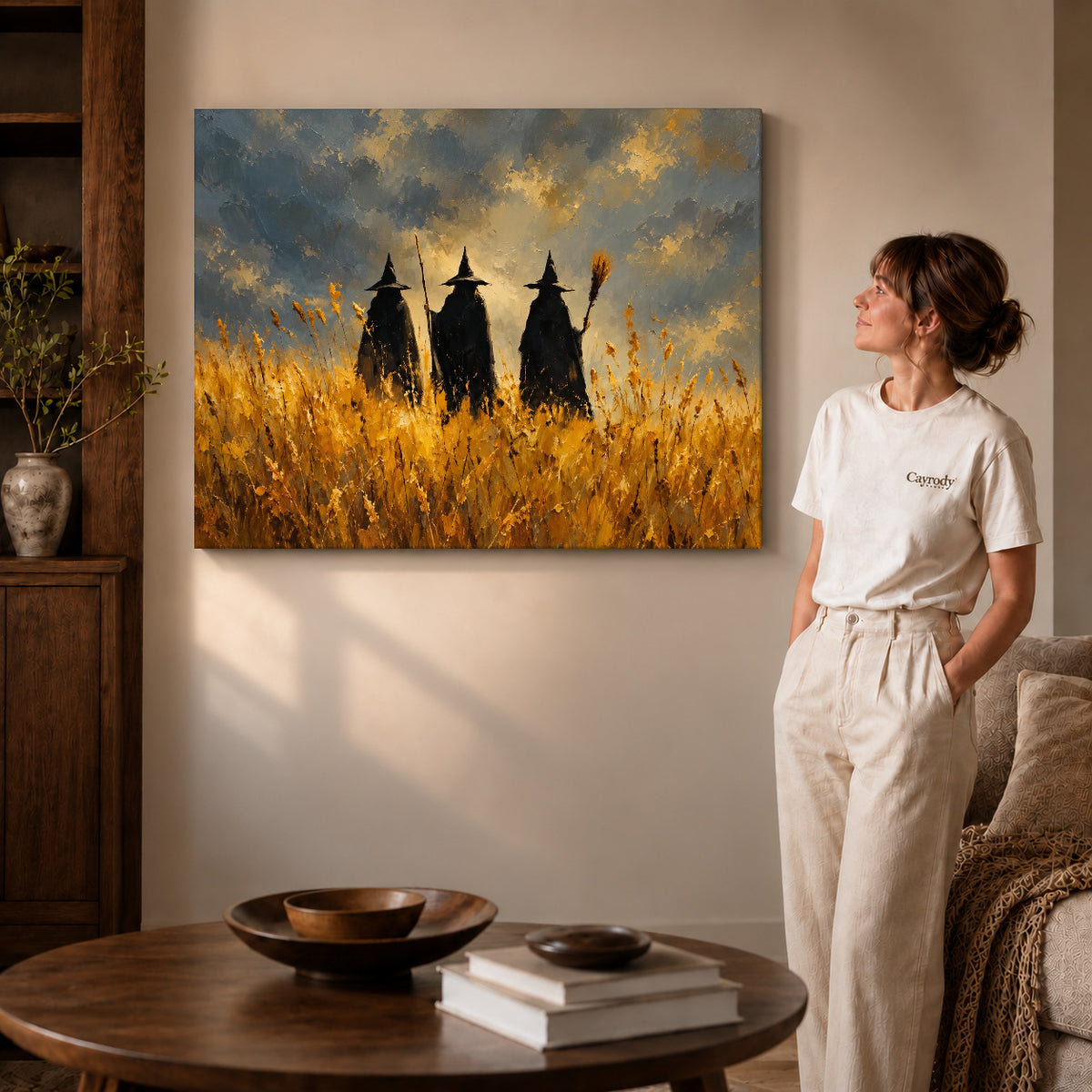 golden meadow witches canvas art on gallery-wrapped canvas with visible edge depth beside a standing woman.