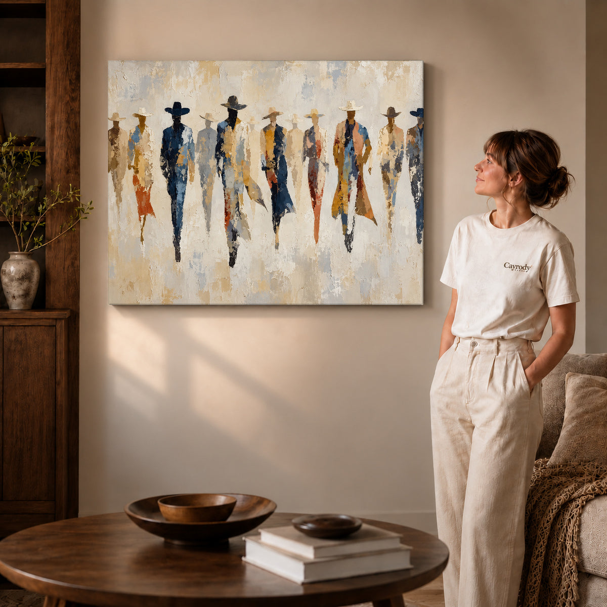 abstract cowboy gathering canvas art on gallery-wrapped canvas with visible edge depth beside a standing woman.