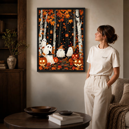 birch forest ghosts canvas art in a black frame beside a woman and round wooden table.