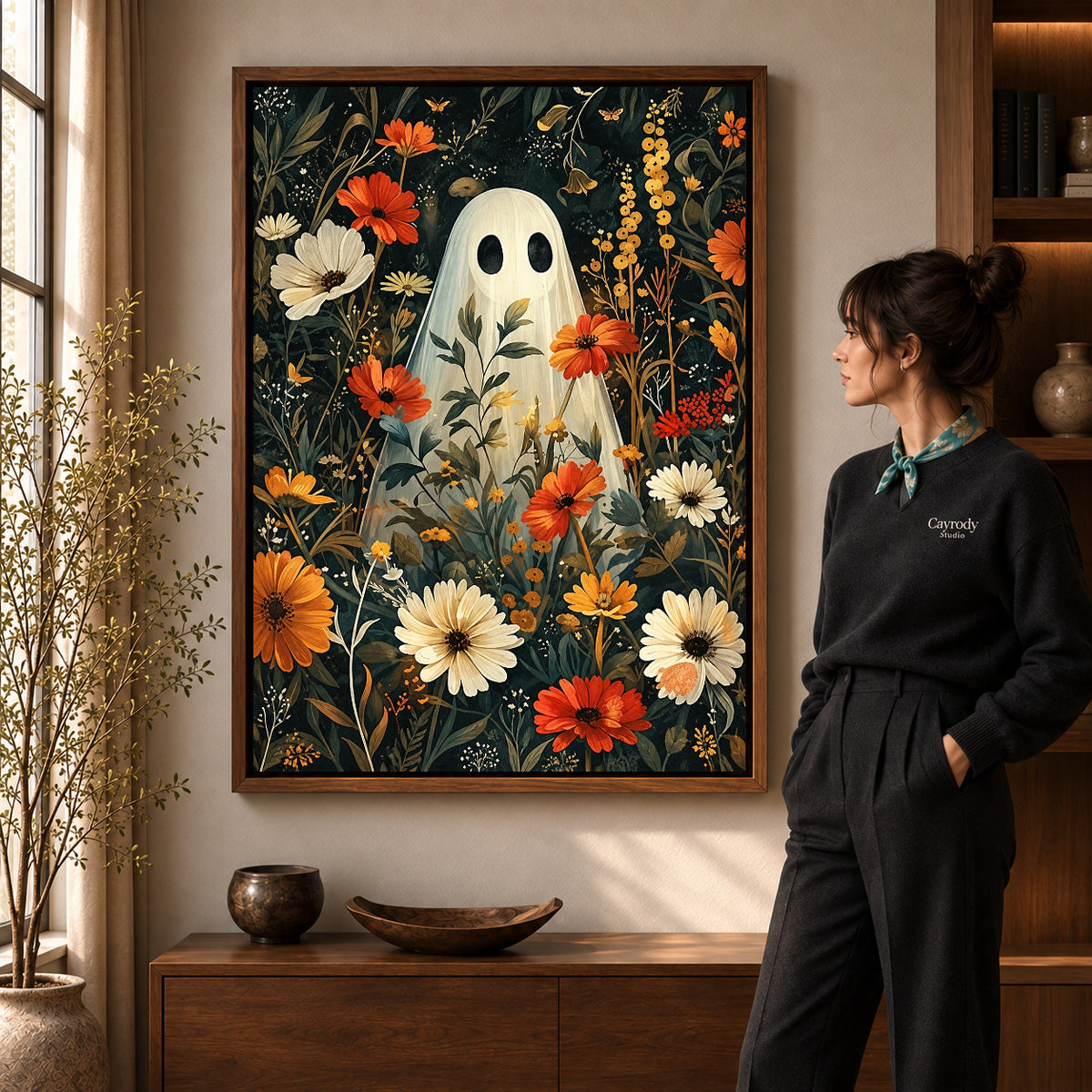 botanical ghost garden canvas art in a walnut frame beside a standing woman and wooden console.