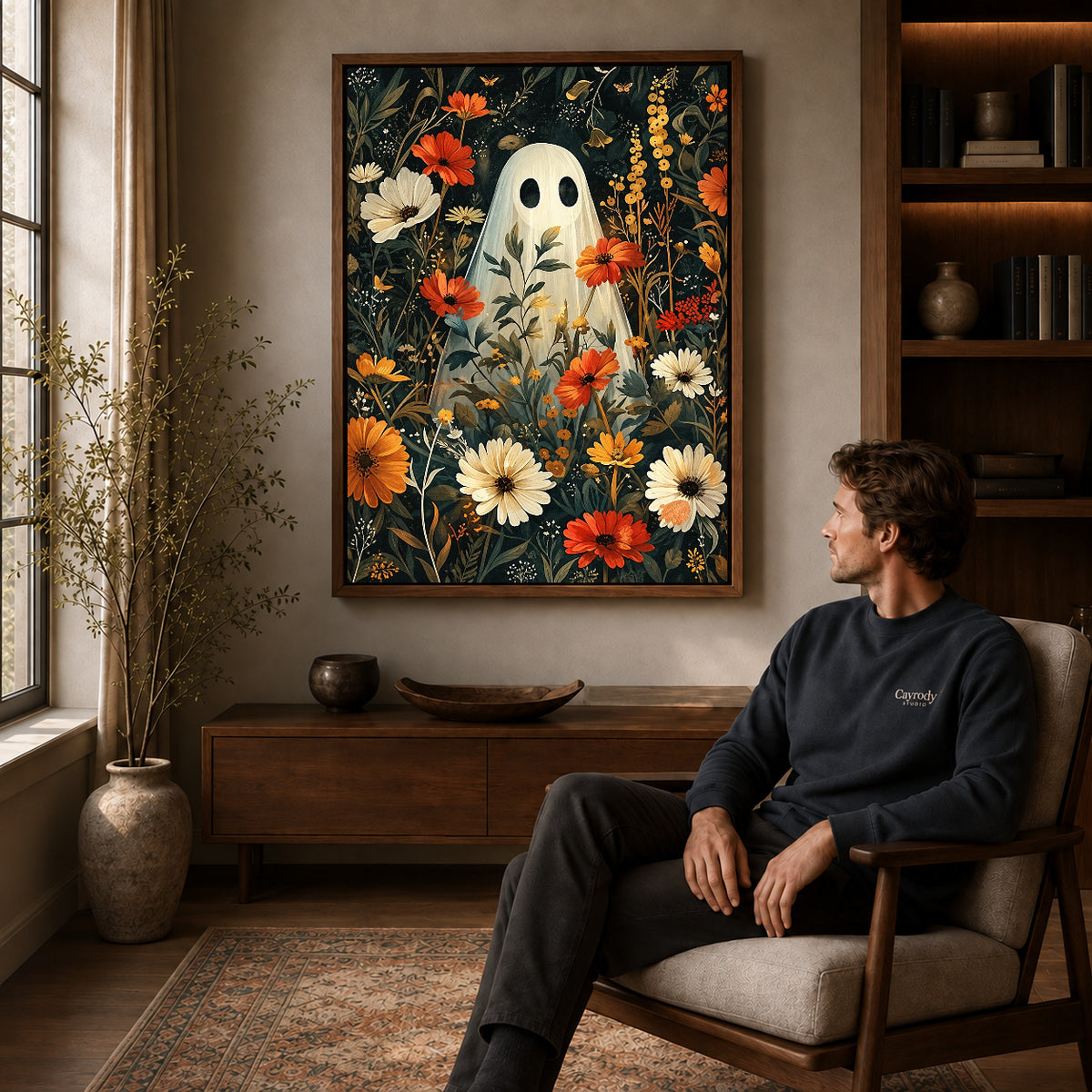 botanical ghost garden canvas art in a walnut frame above a console beside a seated man.