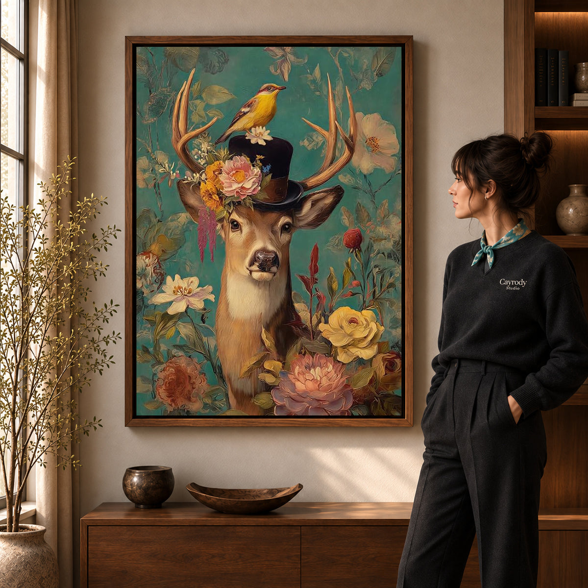 botanical top hat deer canvas art in a walnut frame beside a standing woman and wooden console.
