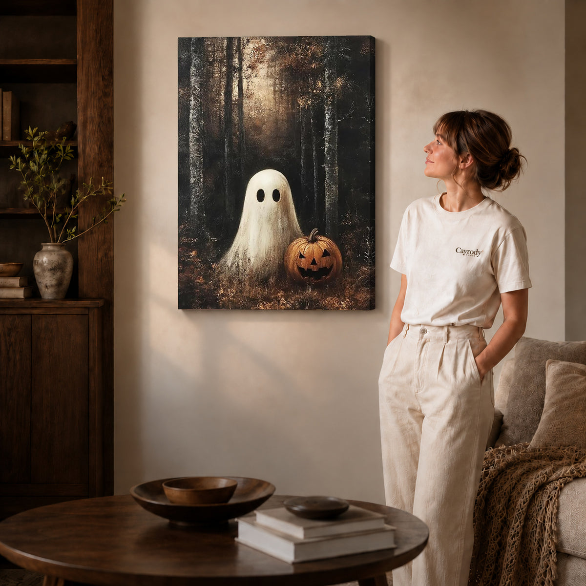 woodland pumpkin ghost canvas art on gallery-wrapped canvas with natural edge shading beside a standing woman.