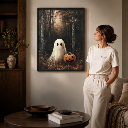 woodland pumpkin ghost canvas art shown in the black frame option against a softly lit wall.