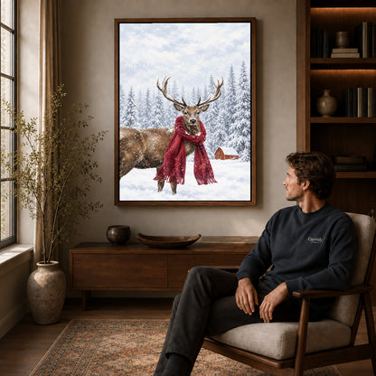 snowy scarf deer canvas art in a walnut frame above a console beside a seated man.