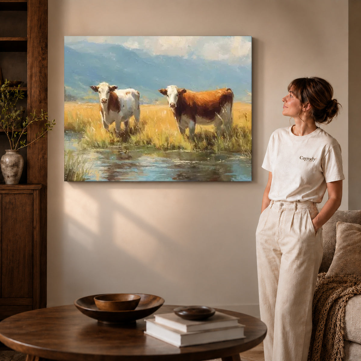 quiet meadow cows canvas art on gallery-wrapped canvas with visible edge depth beside a standing woman.
