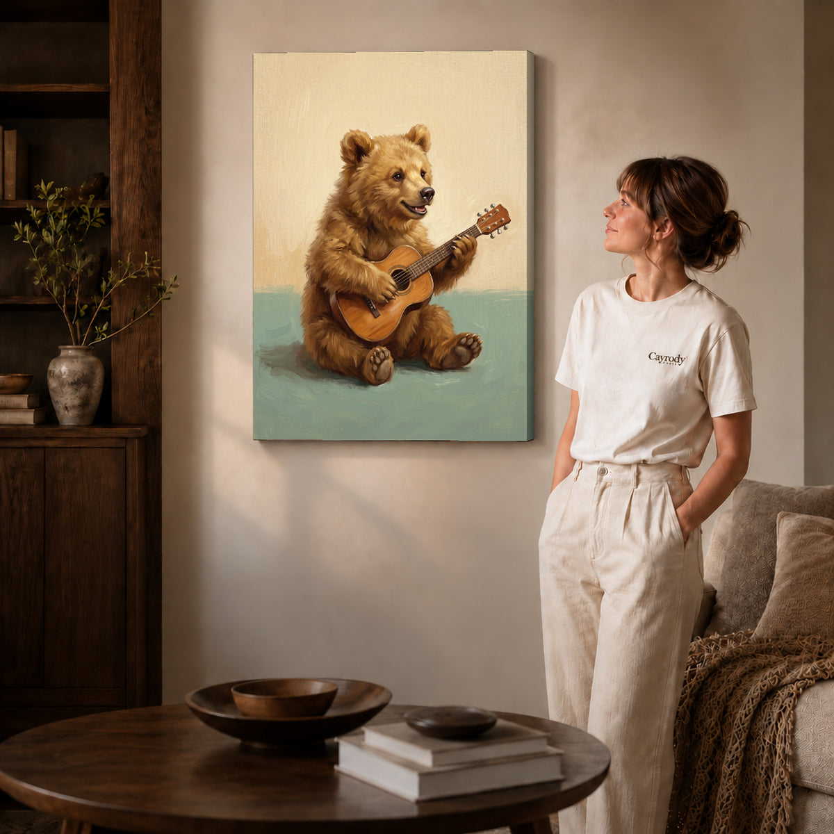 happy guitar bear canvas art on gallery-wrapped canvas with natural edge shading beside a standing woman.