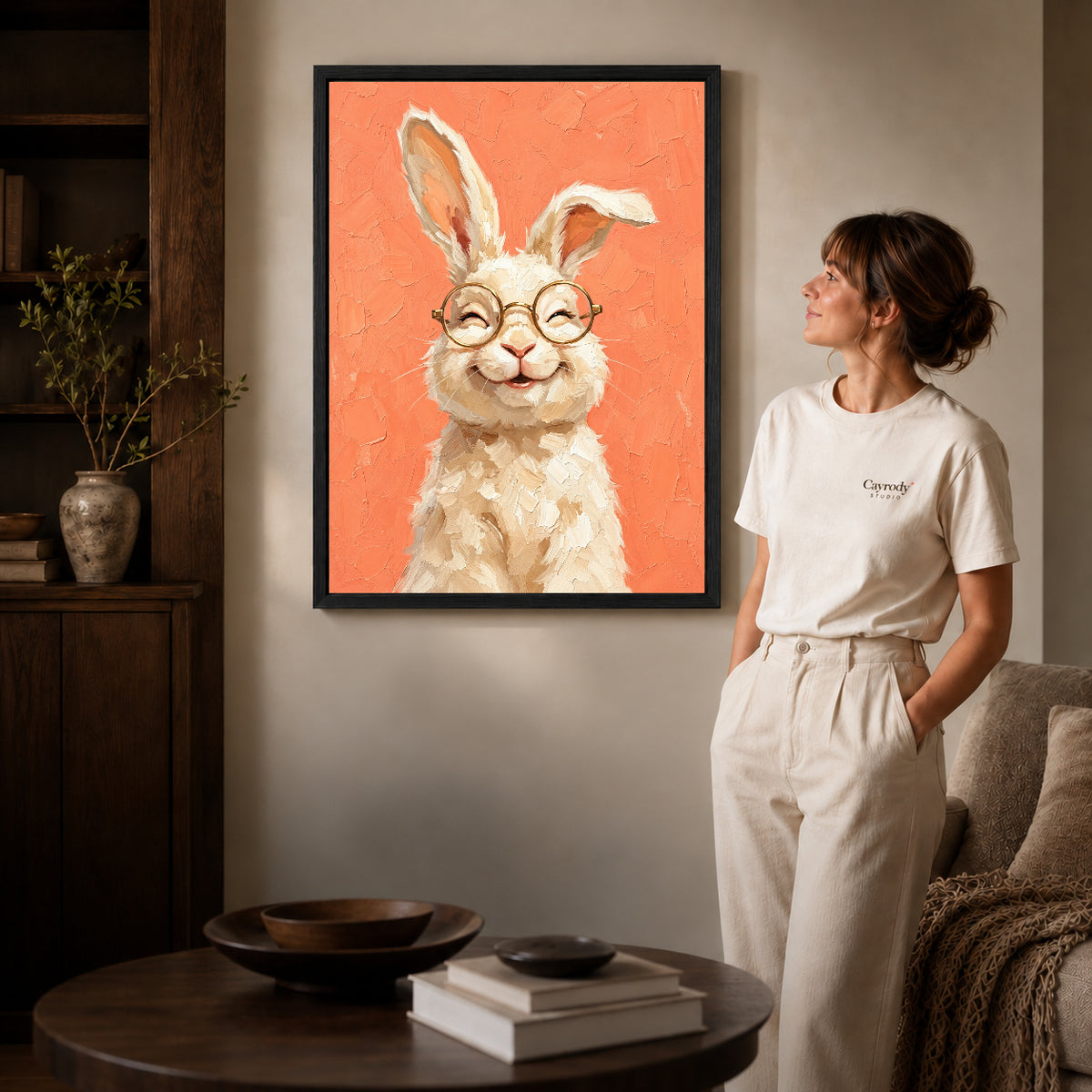 laughing rabbit portrait canvas art shown in the black frame option against a softly lit wall.