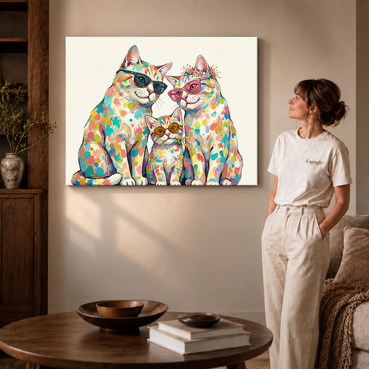 colorful cat family canvas art on gallery-wrapped canvas with visible edge depth beside a standing woman.