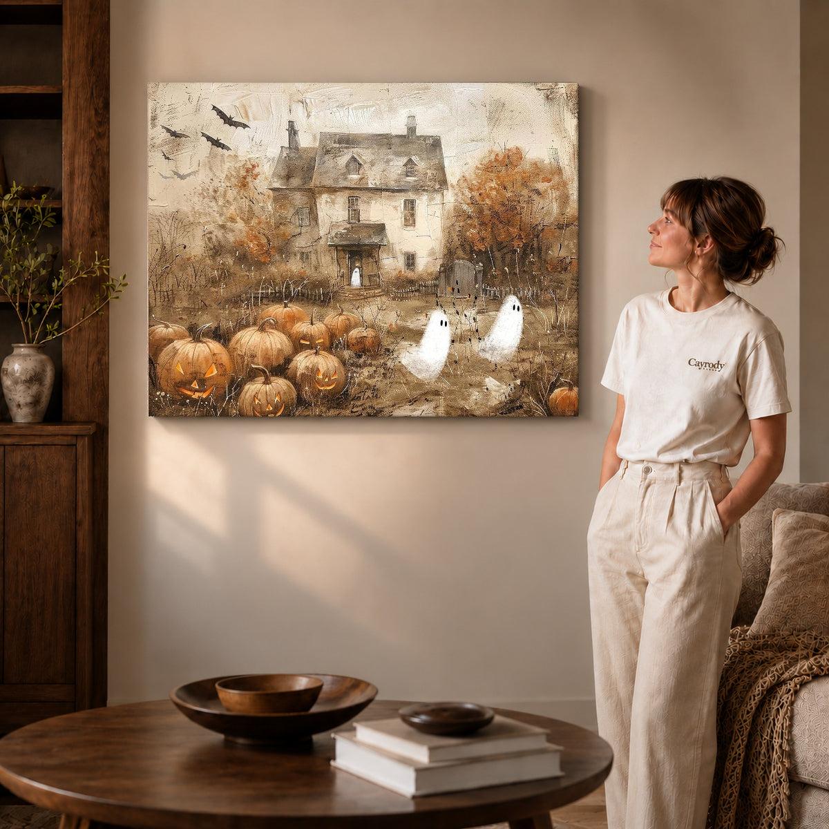 vintage ghost cottage canvas art on gallery-wrapped canvas with visible edge depth beside a standing woman.