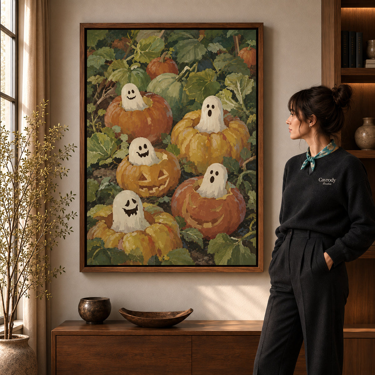 pumpkin ghost friends canvas art shown in the walnut frame option within a warm living room.