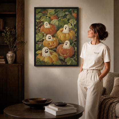 pumpkin ghost friends canvas art shown in the black frame option against a softly lit wall.