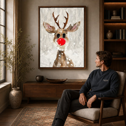 snowy red nose deer canvas art in a walnut frame above a console beside a seated man.