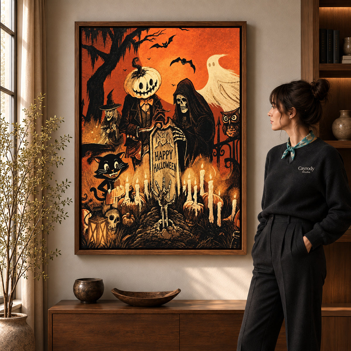 vintage halloween party canvas art in a walnut frame beside a standing woman and wooden console.