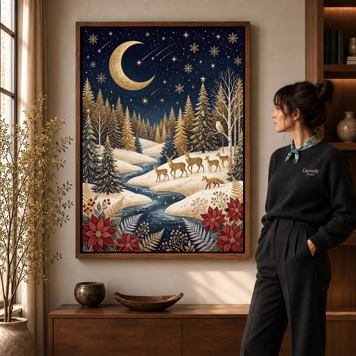 golden winter forest canvas art in a walnut frame beside a standing woman and wooden console.