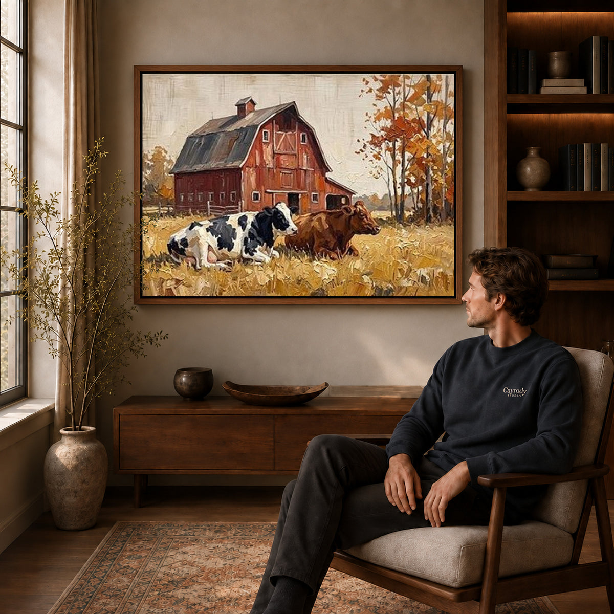 red barn companions canvas art in a walnut frame above a console beside a seated man.