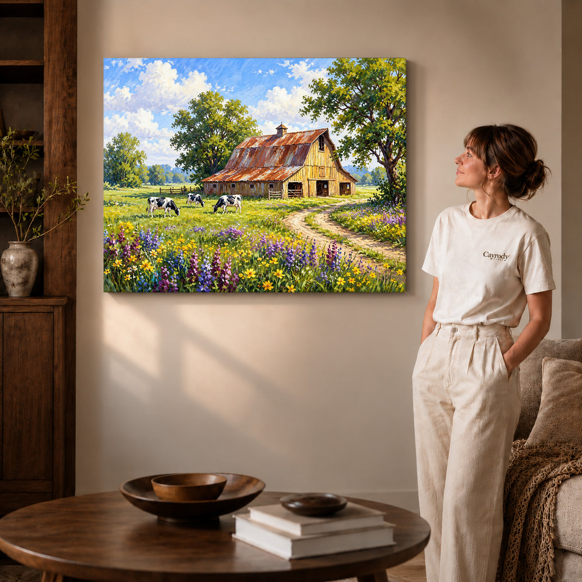 sunlit country barn canvas art on gallery-wrapped canvas with visible edge depth beside a standing woman.