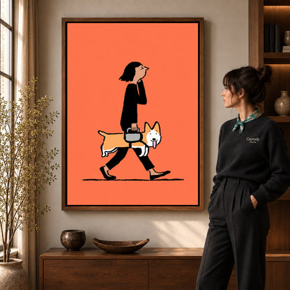 walking corgi companion canvas art in a walnut frame beside a standing woman and wooden console.