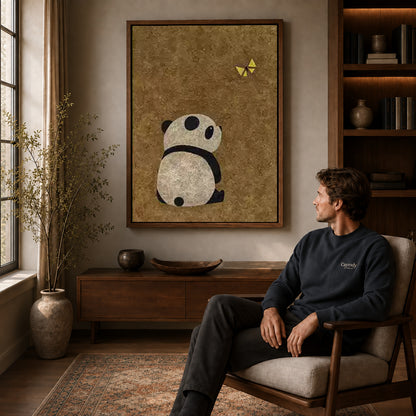 panda butterfly moment canvas art in a walnut frame above a console beside a seated man.