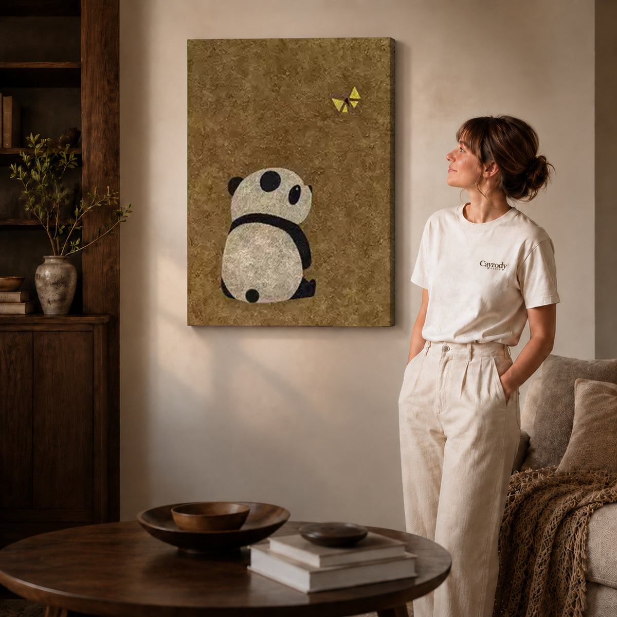 panda butterfly moment canvas art on gallery-wrapped canvas with natural edge shading beside a standing woman.