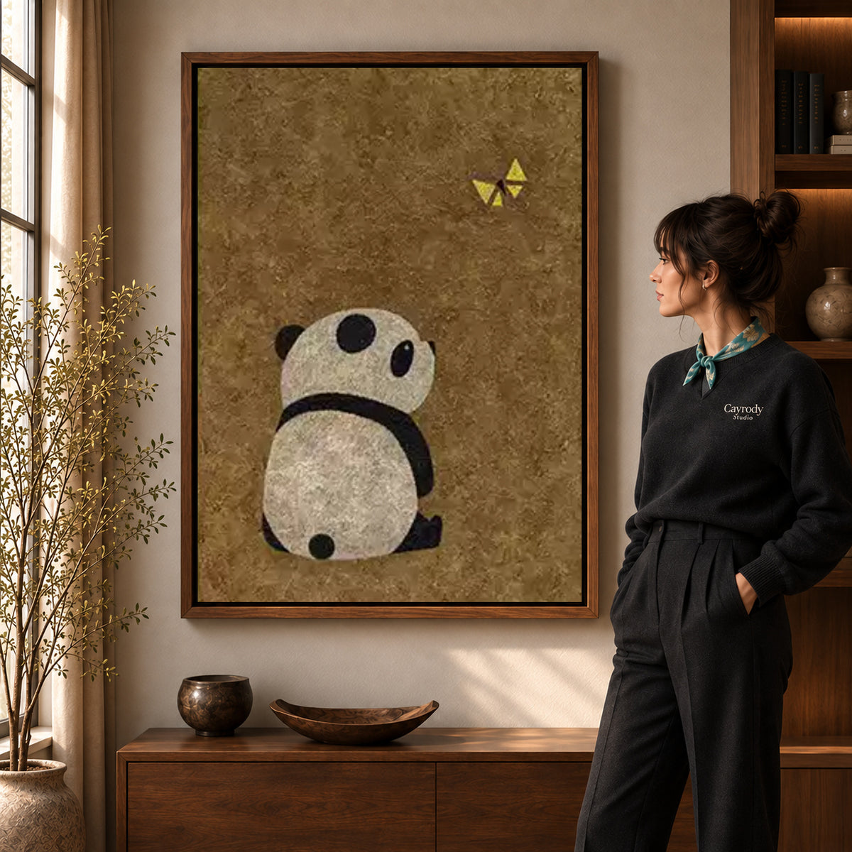 panda butterfly moment canvas art shown in the walnut frame option within a warm living room.