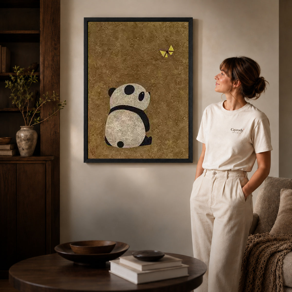 panda butterfly moment canvas art shown in the black frame option against a softly lit wall.