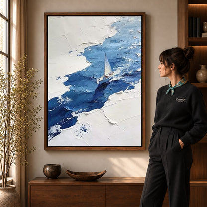 blue impasto sailboat canvas art shown in the walnut frame option within a warm living room.