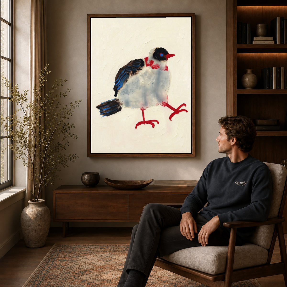 playful stepping bird canvas art in a walnut frame above a console beside a seated man.