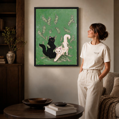 lucky cat gathering canvas art in a black frame beside a woman and round wooden table.