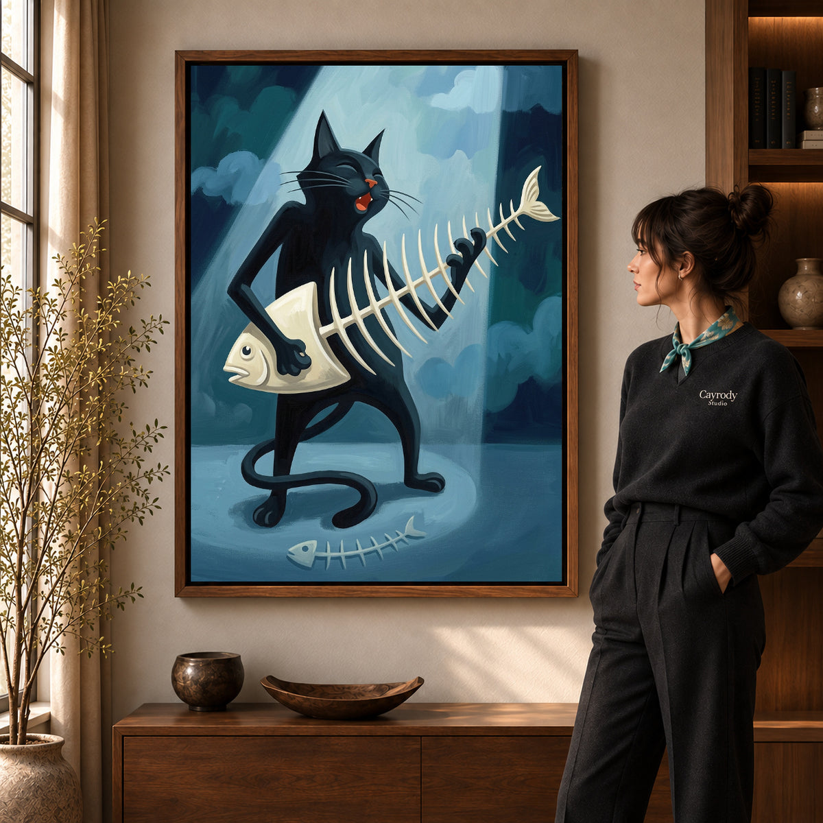 fishbone guitar cat canvas art in a walnut frame beside a standing woman and wooden console.