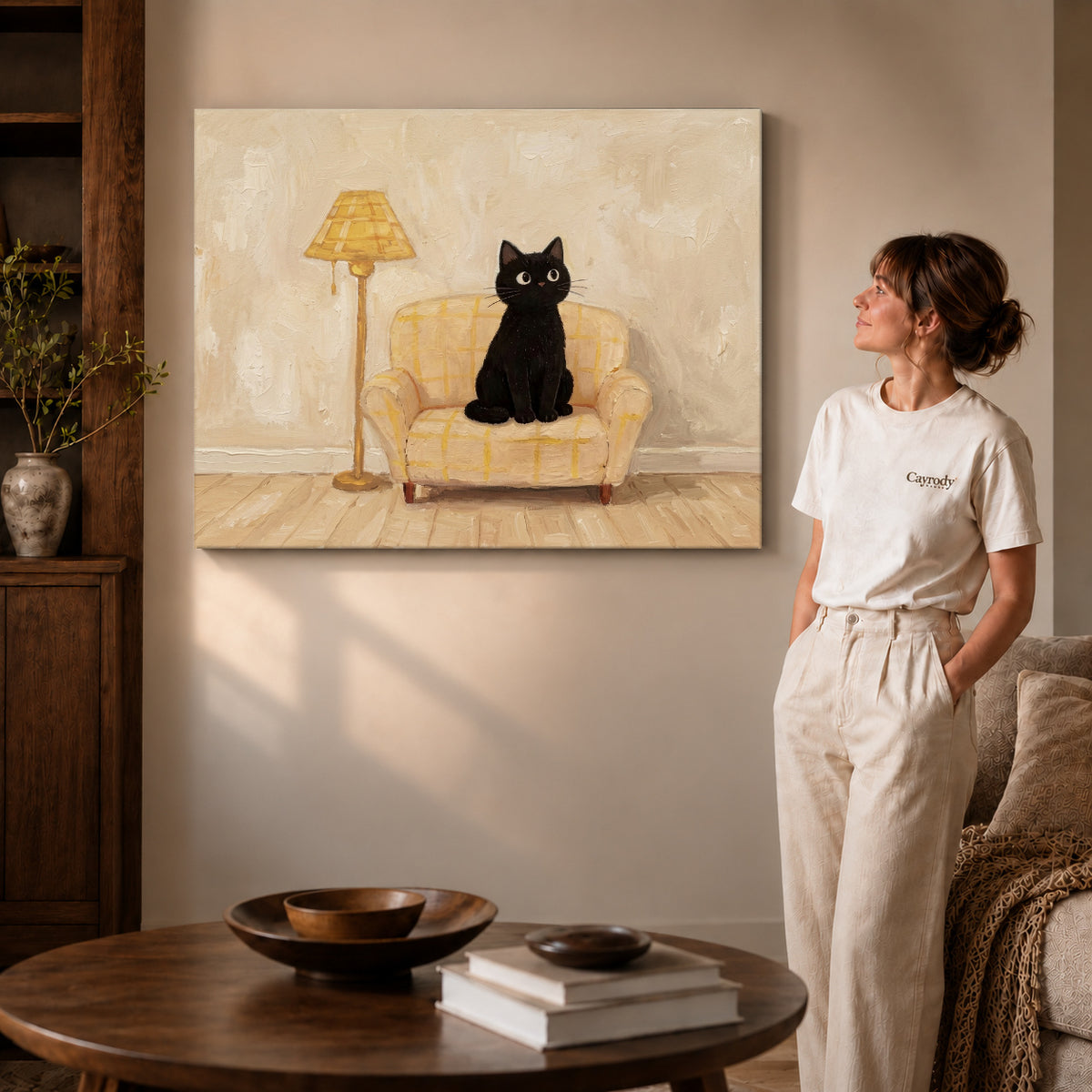 cozy armchair cat canvas art on gallery-wrapped canvas with visible edge depth beside a standing woman.