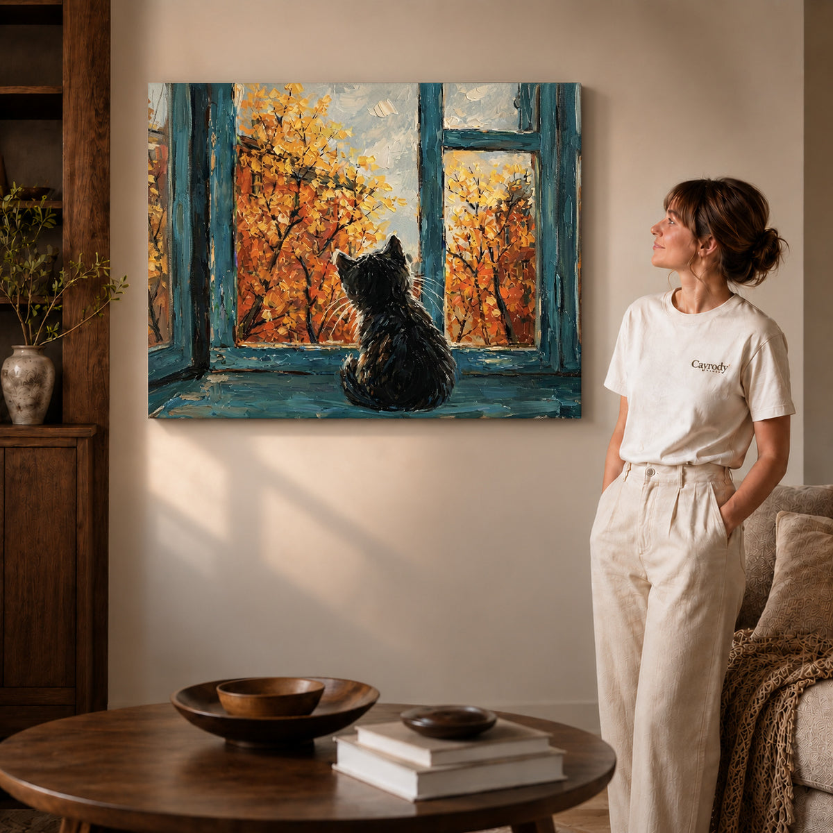 autumn window cat canvas art on gallery-wrapped canvas with visible edge depth beside a standing woman.