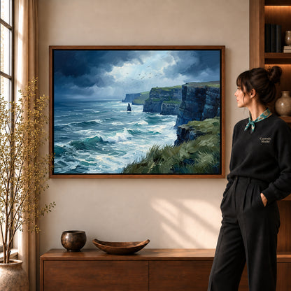 wild coastal cliffs canvas art in a walnut frame beside a standing woman and wooden console.