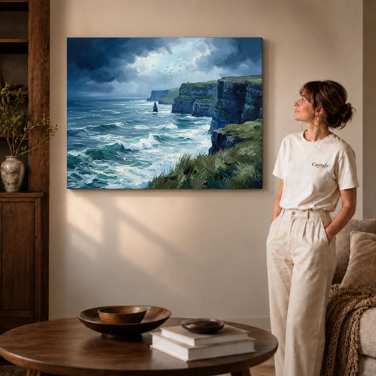 wild coastal cliffs canvas art on gallery-wrapped canvas with visible edge depth beside a standing woman.