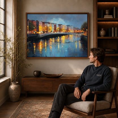 city bridge reflections canvas art in a walnut frame above a console beside a seated man.